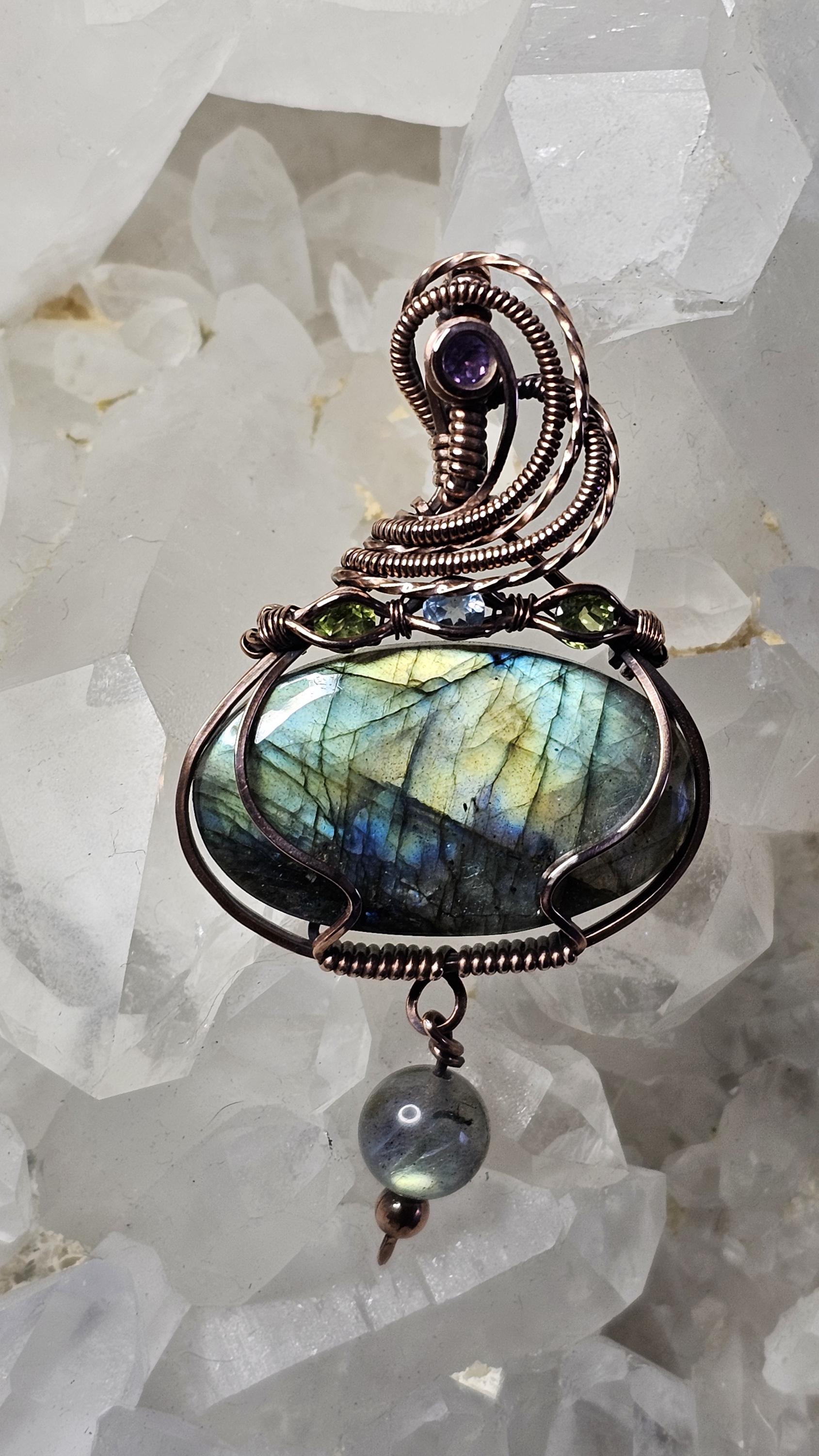 Labradorite, accented with a Amethyst at the bail and 2 Peridots and a Swiss Blue Topaz.