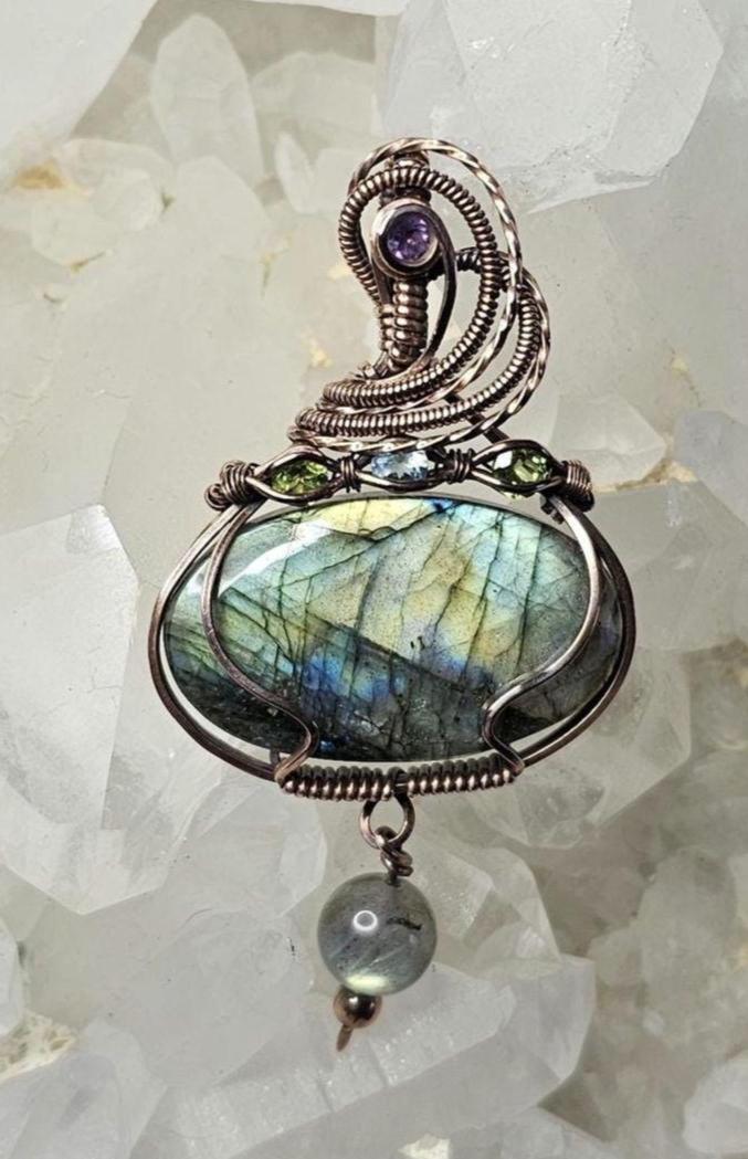 Labradorite, accented with a Amethyst at the bail and 2 Peridots and a Swiss Blue Topaz.