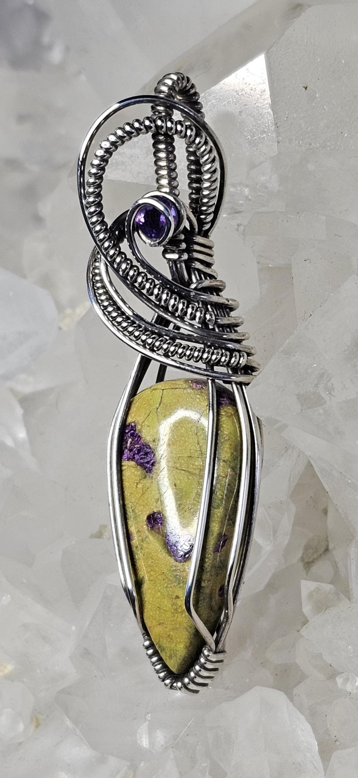 Atlantisite accented with a faceted Amethyst. Wrapped in Sterling Silver