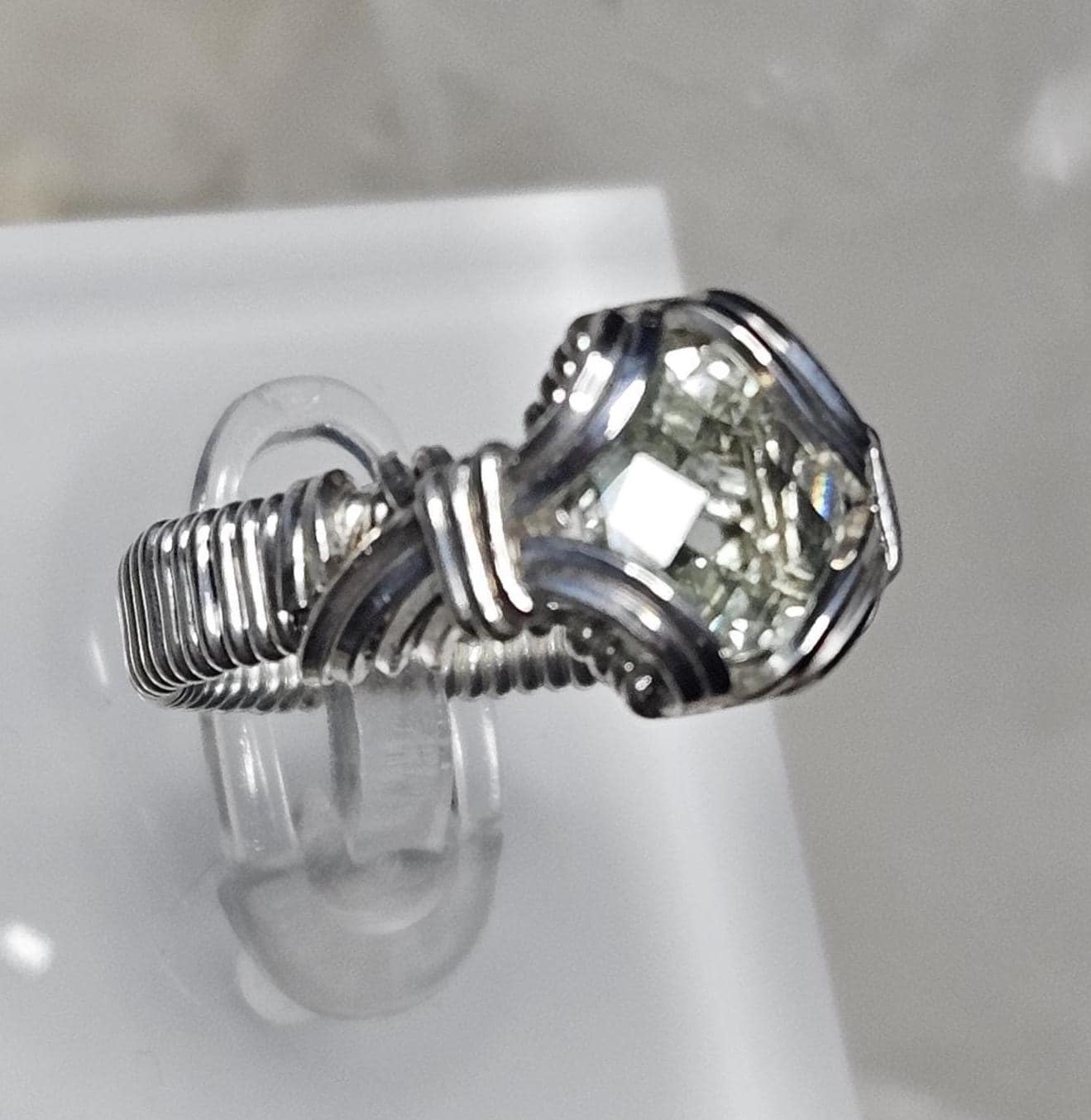 A faceted Green Amethyst, hand woven in sterling silver. Size 7.