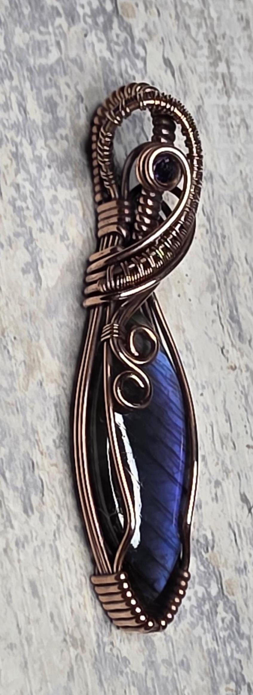 Hand Woven Copper Purple Labradorite Pendant accented with an Iolite.
