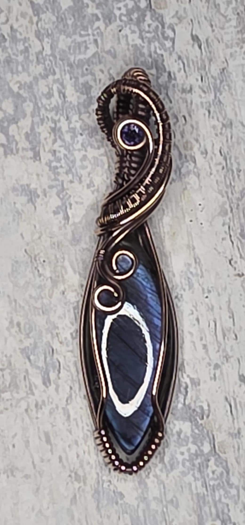 Hand Woven Copper Purple Labradorite Pendant accented with an Iolite.