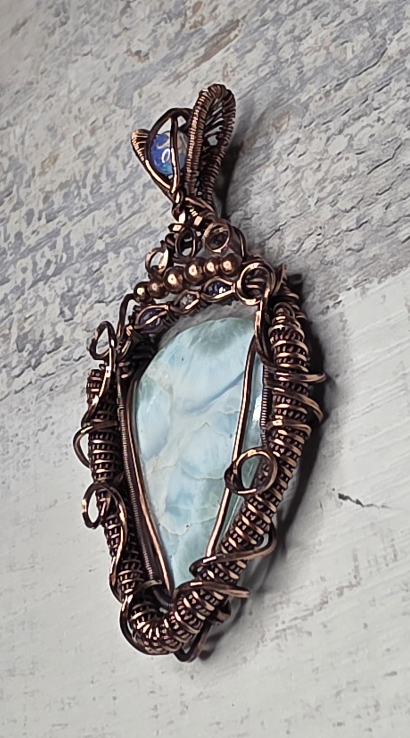 A bright Larimar accented with an Opal, Tanzanite and White Sapphire.