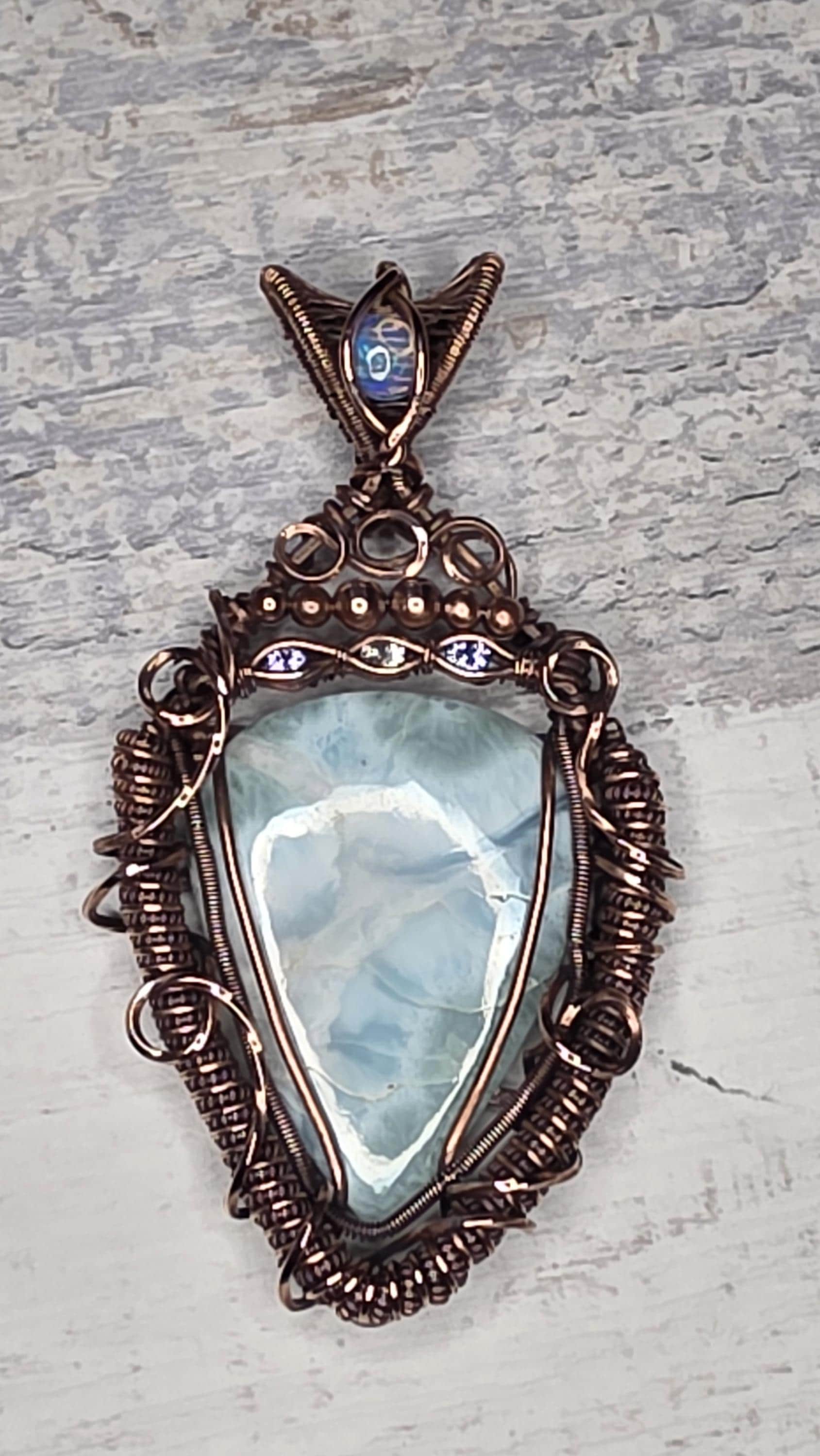 A bright Larimar accented with an Opal, Tanzanite and White Sapphire.