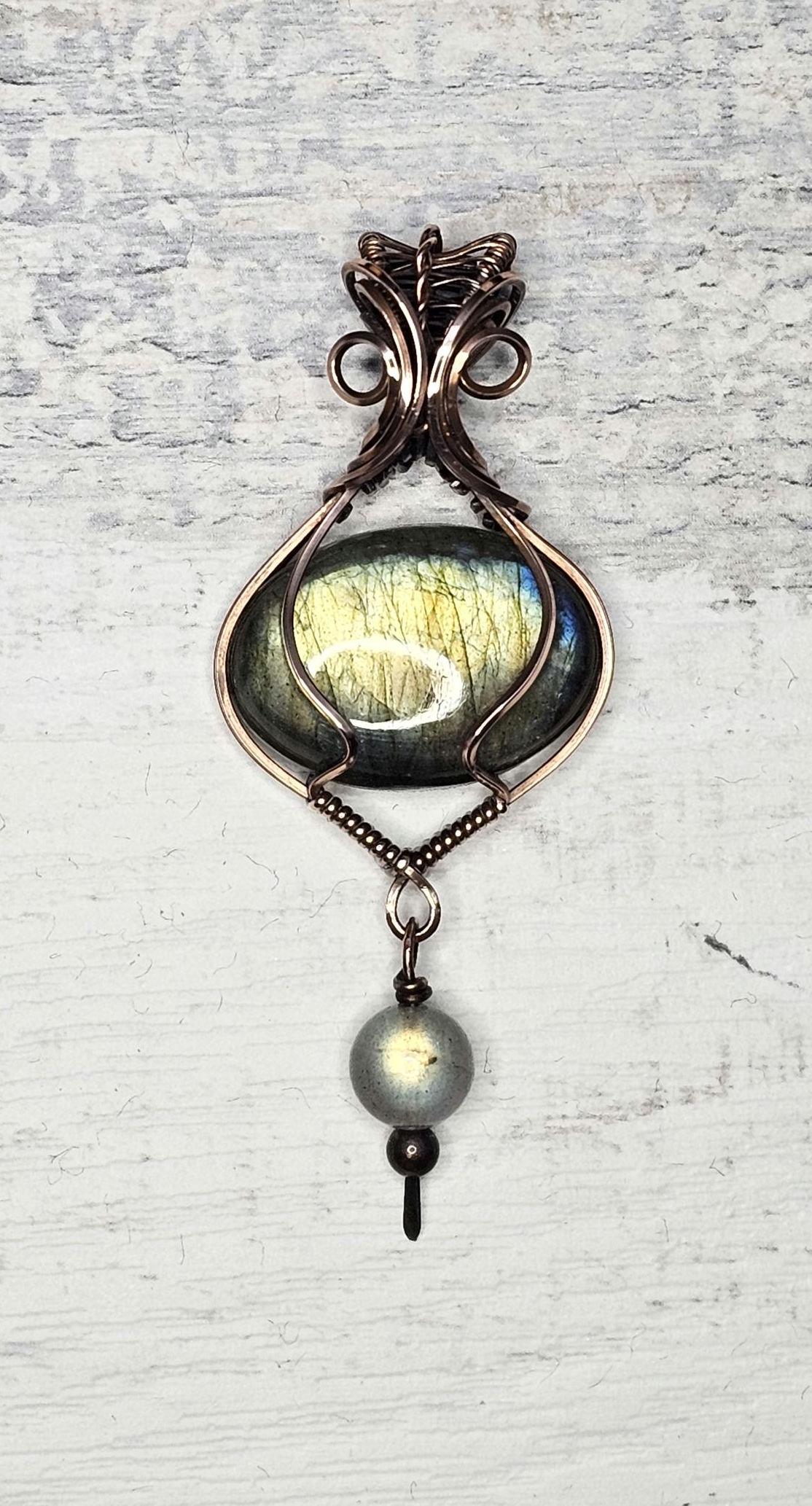 Labradorite, wrapped in Copper and accented with a Labradorite bead.