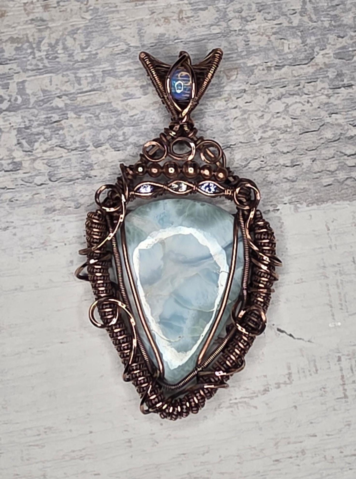 A bright Larimar accented with an Opal, Tanzanite and White Sapphire.