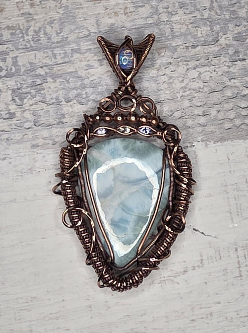 A bright Larimar accented with an Opal, Tanzanite and White Sapphire.