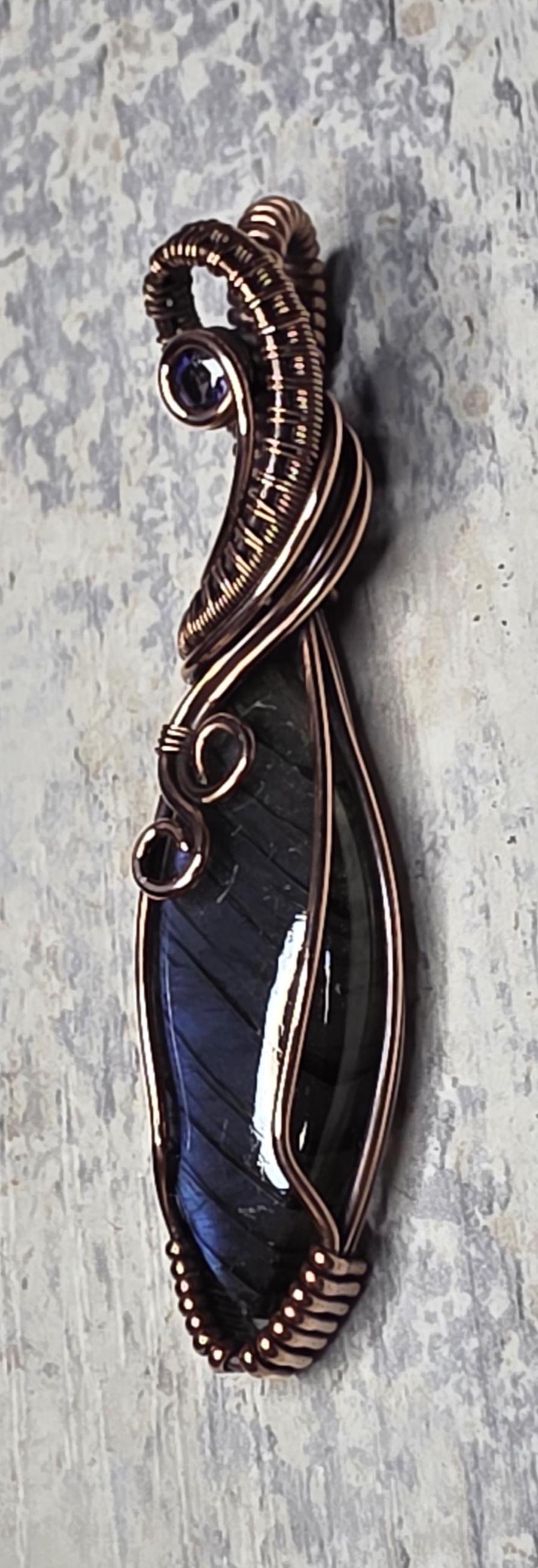 Hand Woven Copper Purple Labradorite Pendant accented with an Iolite.