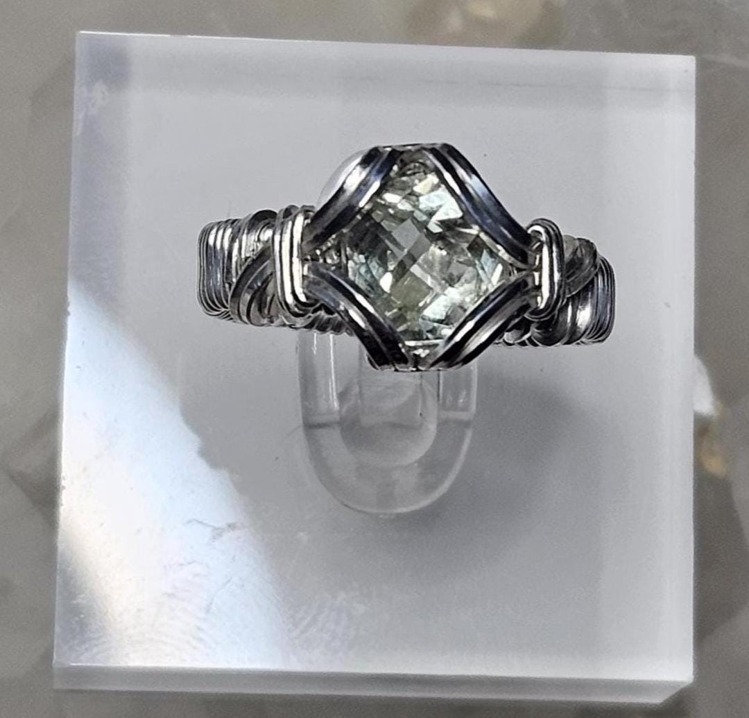 A faceted Green Amethyst, hand woven in sterling silver. Size 7.