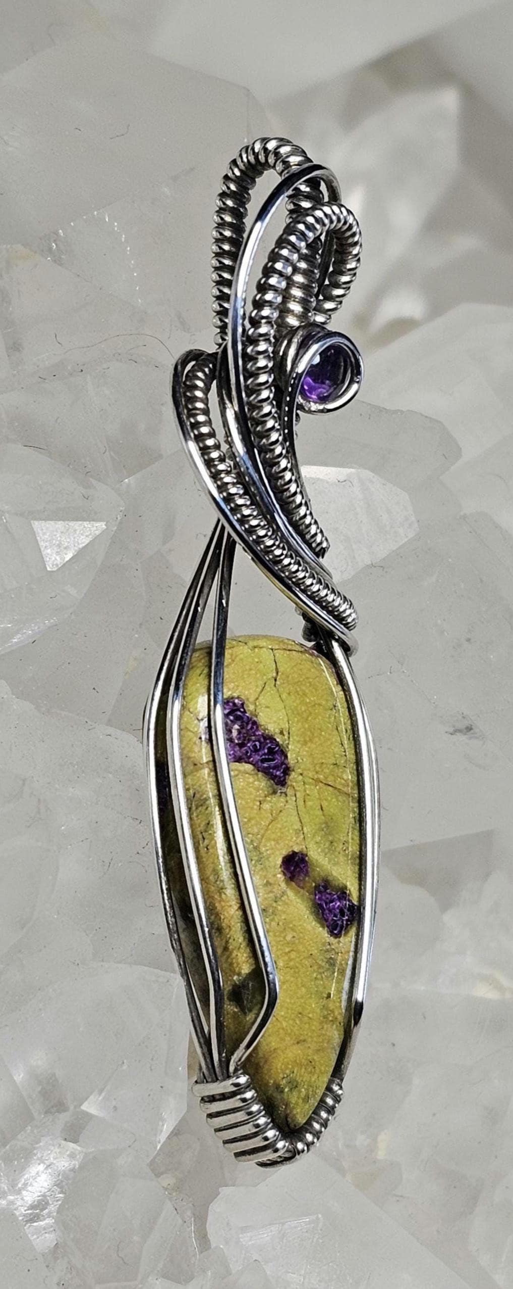 Atlantisite accented with a faceted Amethyst. Wrapped in Sterling Silver