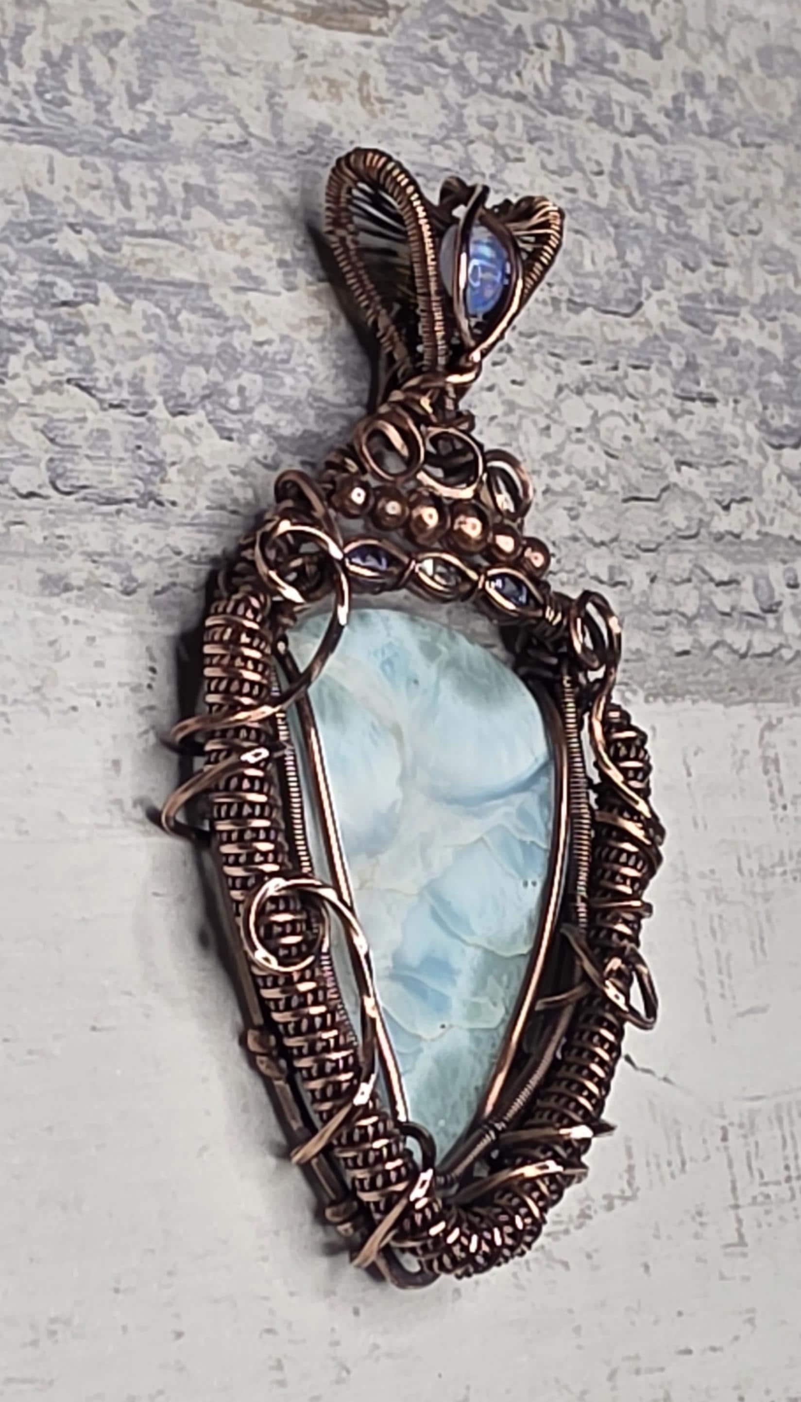 A bright Larimar accented with an Opal, Tanzanite and White Sapphire.