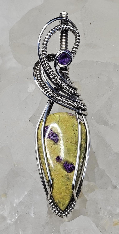 Atlantisite accented with a faceted Amethyst. Wrapped in Sterling Silver